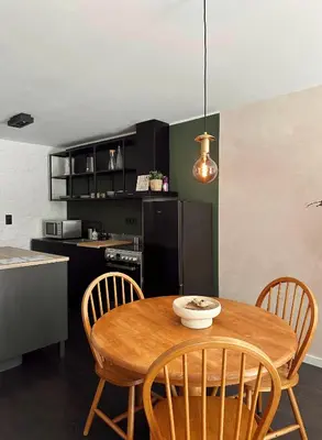 a kitchen and dining room with a wooden table and chairs at Residentie Papillon in Hasselt