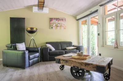 a living room with a couch and a coffee table at Corgi-Flowerhuisje in Lanaken