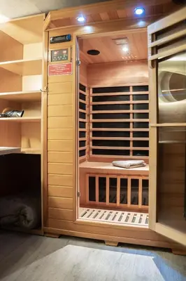 a sauna with wooden walls and shelves at Corgi-Flowerhuisje in Lanaken