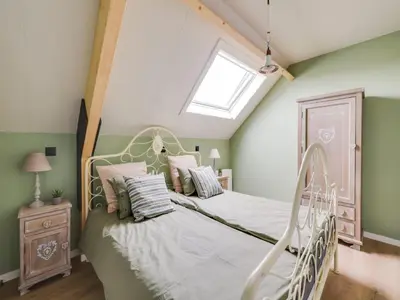 a bedroom with a bed and a skylight at Vakantiehuis Bonne Home in Bree