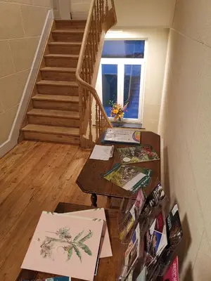 a room with stairs and paintings on a table at Manoir du Moulin in Berloz