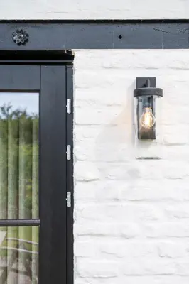a light on the side of a building with a window at Stee10 in Lanaken