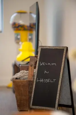 a chalkboard sign sitting on a table with a hat at Chill Hill in Hasselt