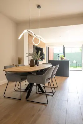 a dining room with a wooden table and chairs at Chill Hill in Hasselt