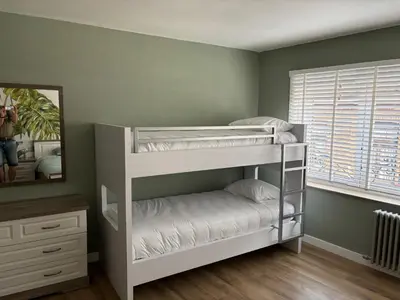 two bunk beds in a room with a mirror at Romagna in Tongeren