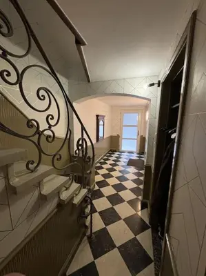 a hallway with a black and white checkered floor at Romagna in Tongeren