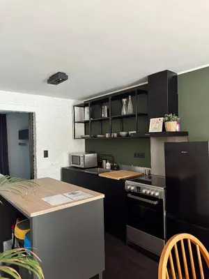 a kitchen with black cabinets and a counter top at Residentie Papillon in Hasselt