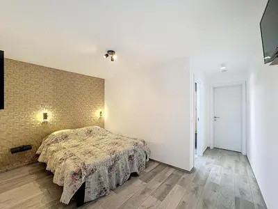 a bedroom with a bed and a wall at Residence pascalino in Ans