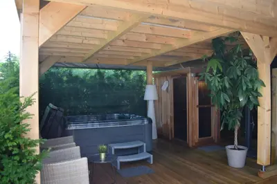 a pergola with a hot tub on a patio at Luxury House in Remersdaal