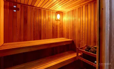 a small wooden sauna with a light in it at Luxury House in Remersdaal