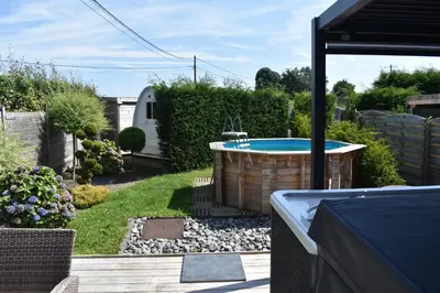 a backyard with a hot tub in a yard at Luxury House in Remersdaal