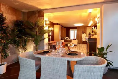 a dining room with a table and chairs at Luxury House in Remersdaal