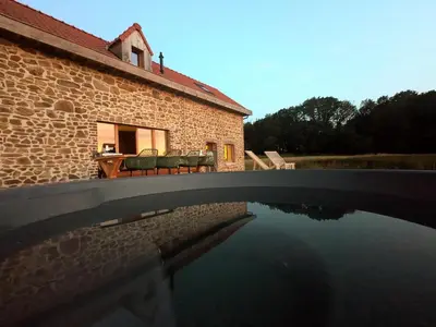 a house with a pool of water in front of it at La Petite Maison dans la Prairie in Pepinster