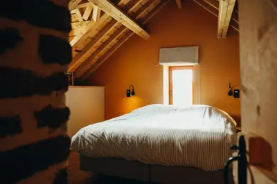 a bedroom with a bed and a window at La Petite Maison dans la Prairie in Pepinster