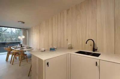 a kitchen with a sink and a table with chairs at Lodge met Jacuzzi - 8 personen - Woodz Lodges in Heusden - Zolder