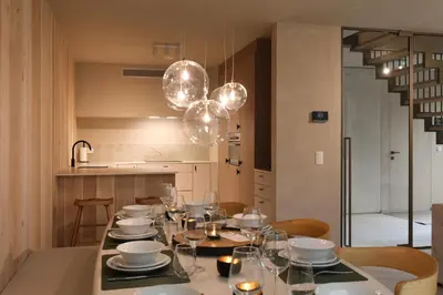a dining room with a table with plates and glasses at Lodge met Jacuzzi - 8 personen - Woodz Lodges in Heusden - Zolder