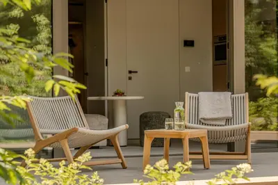 two chairs and a coffee table on a porch at Suite Toegankelijk | 2 personen in Heusden - Zolder