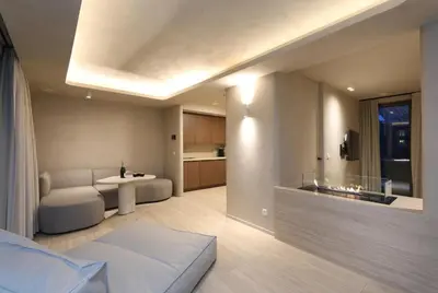 a living room with a bed and a kitchen at Wellness Suite - 2 personen - Woodz Lodges in Heusden - Zolder