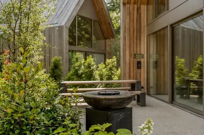 a bird bath sitting in the middle of a garden at Lodge - 8 personen - Woodz Lodges in Heusden - Zolder
