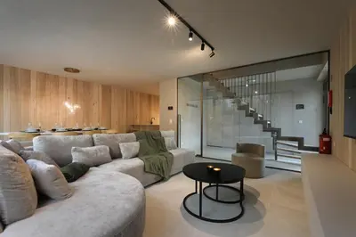 a living room with a couch and a table at Groepslodge - 10 personen - Woodz Lodges in Heusden - Zolder