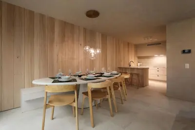 a dining room with a white table and chairs at Groepslodge - 10 personen - Woodz Lodges in Heusden - Zolder