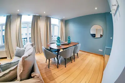 a living room with a table and a couch at Urbanchic Duplex Adalbert 2A in Liège