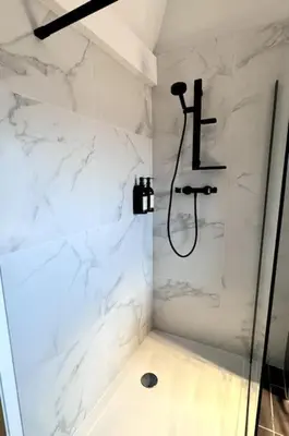 a white bathroom with a shower with at Urbanchic Duplex Adalbert 2A in Liège