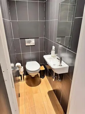 a small bathroom with a toilet and a sink at Urbanchic Duplex Adalbert 2A in Liège