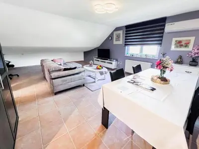 a living room with a white table and a couch at Modern Loft with 2 bedrooms near Sint Truiden in Herk-de-Stad