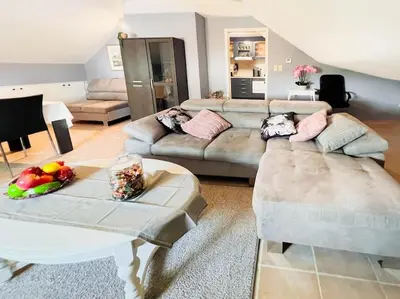 a living room with two couches and a table at Modern Loft with 2 bedrooms near Sint Truiden in Herk-de-Stad