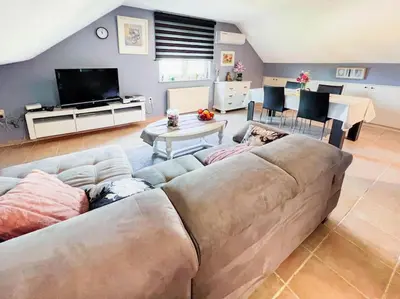 a living room with a large couch and a tv at Modern Loft with 2 bedrooms near Sint Truiden in Herk-de-Stad