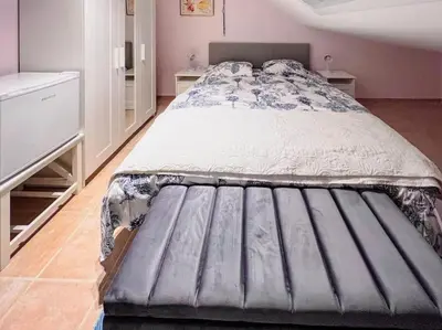 a bedroom with a large bed with a mattressvisorvisor at Modern Loft with 2 bedrooms near Sint Truiden in Herk-de-Stad