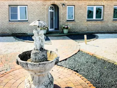 a fountain with a statue of a bear and an umbrella at Modern Loft with 2 bedrooms near Sint Truiden in Herk-de-Stad