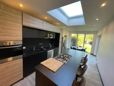 a kitchen with a black counter top and a sink at Au 11801 Bel appartement moderne in Loncin