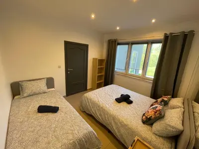 a bedroom with two beds and a window at Au 11801 Bel appartement moderne in Loncin