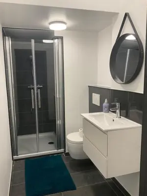 a bathroom with a shower and a sink and a toilet at Au 11801 Bel appartement moderne in Loncin