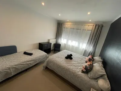 a bedroom with two beds with stuffed animals on them at Au 11801 Bel appartement moderne in Loncin