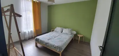 a small bedroom with a bed and a window at Au 167 Maison de Village in Seraing