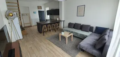 a living room with a couch and a table at Au 169 La maison du coin in Flémalle-Grande