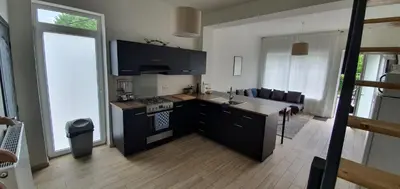 a kitchen with a sink and a stove top oven at Au 169 La maison du coin in Flémalle-Grande
