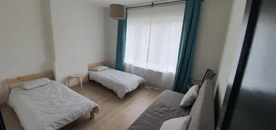 a small room with two beds and a window at Au 169 La maison du coin in Flémalle-Grande
