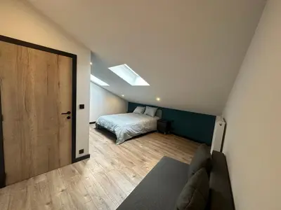 a bedroom with a bed and a skylight at Au 171 Le loft avec un sauna in Flémalle-Grande