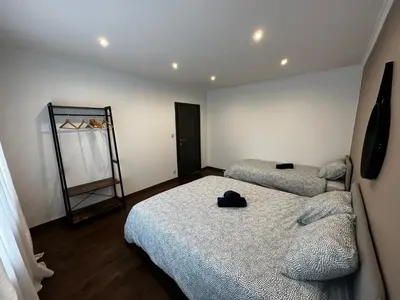a bedroom with two beds and a mirror on the wall at Au 11811 Bel appartement cosy in Loncin