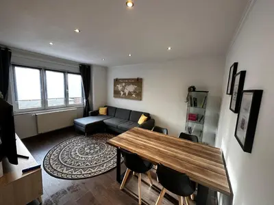 a living room with a couch and a table at Au 11811 Bel appartement cosy in Loncin