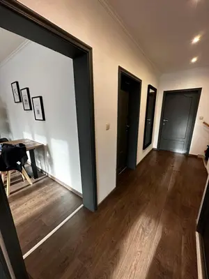 an empty room with a hallway with a table and doors at Au 11811 Bel appartement cosy in Loncin