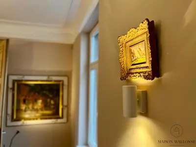 a picture hanging on a wall with a picture on it at La maison de Maître - Grand Jardin, Face à la Meuse in Hermalle-sous-Argenteau