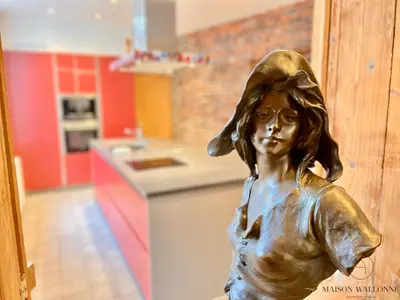 a bronze statue of a young girl in a kitchen at La maison de Maître - Grand Jardin, Face à la Meuse in Hermalle-sous-Argenteau