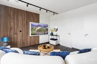 a living room with a couch and a table at Lodge 4 you gite de luxe pour 4 personnes in Verviers