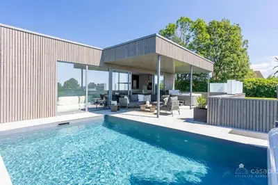 a swimming pool in front of a house at Lodge 4 you gite de luxe pour 4 personnes in Verviers