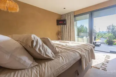 a bedroom with a bed and a large window at Gite SIWA pour 2 personnes in Verviers
